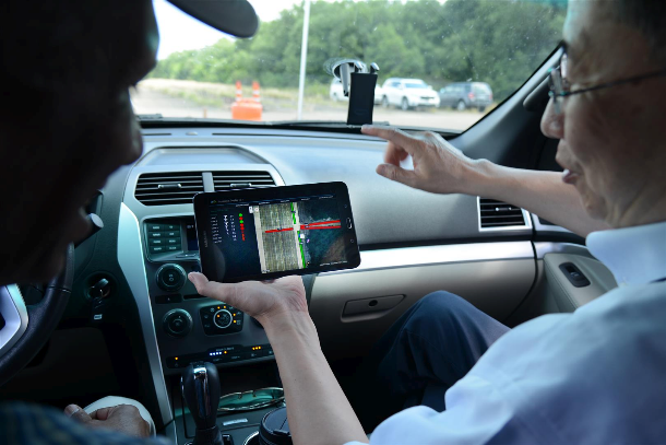 Researcher analyzing connected vehicle information.
