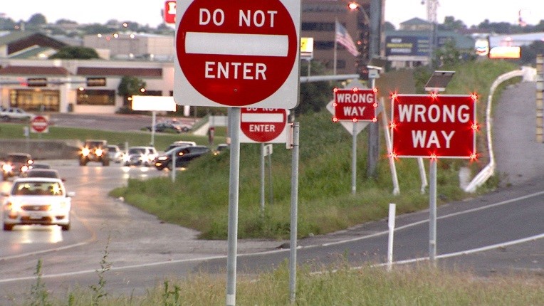 Wrong-way warning signs installed along a roadway.